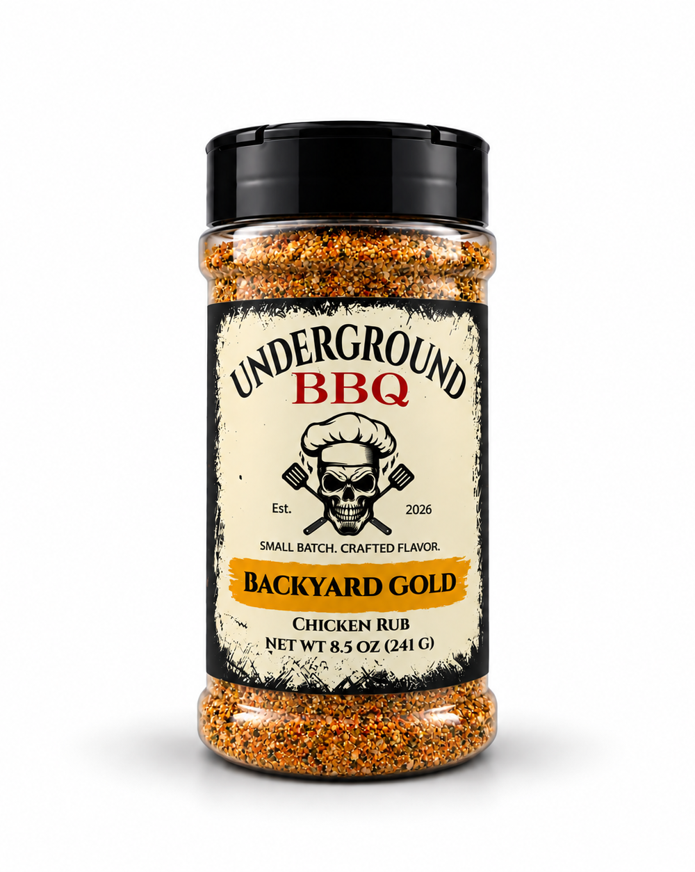 Backyard Gold - Underground BBQ Tall glass jar of Backyard Gold Chicken Rub from Underground BBQ, orange coarse granules visible through the clear bottle with a black lid.
